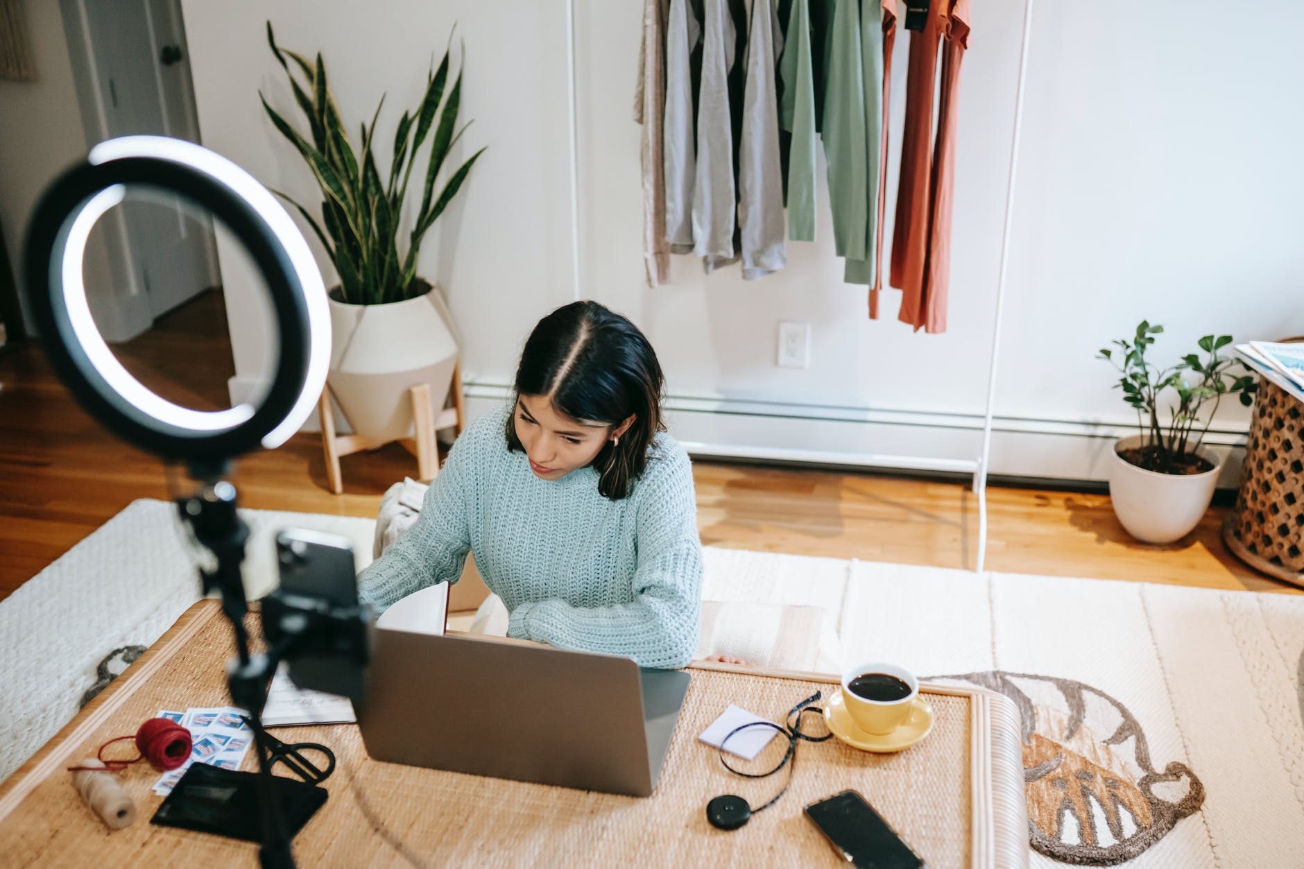 focused woman working at desk on laptop in studio