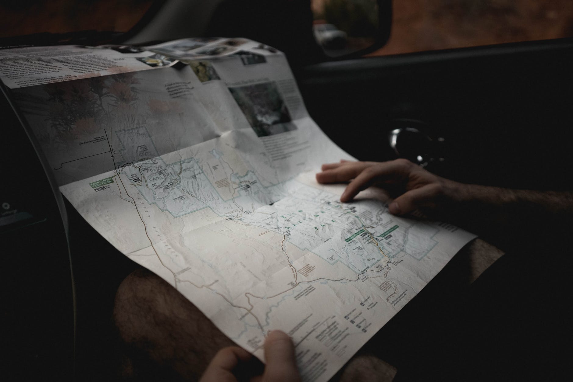 crop man with map in automobile