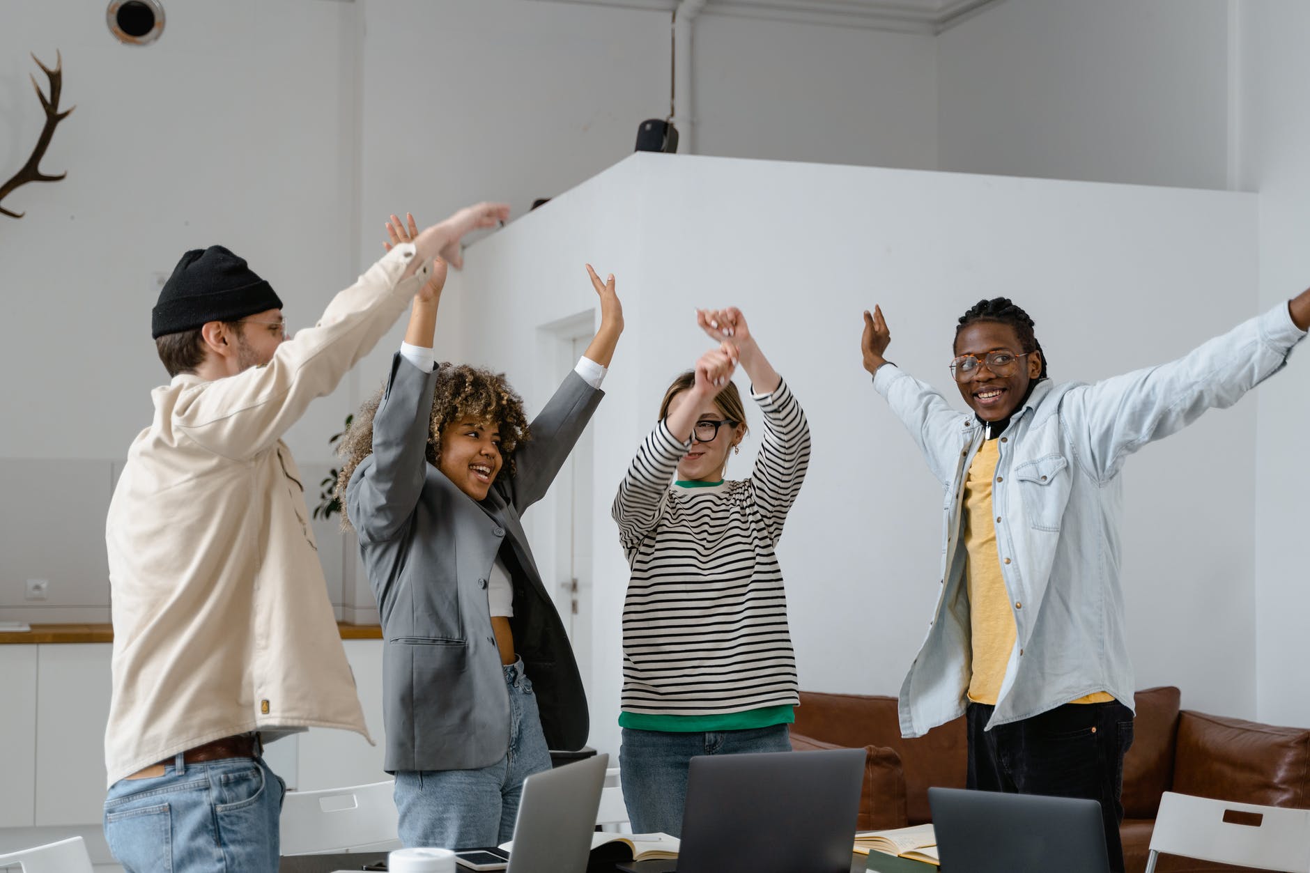 group of interracial people rejoicing with hands raised