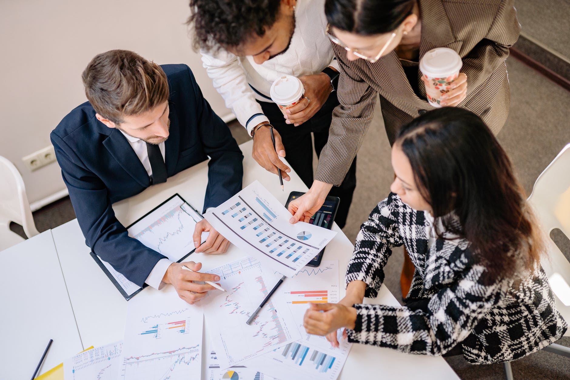 a group of business partner looking at a graph print out